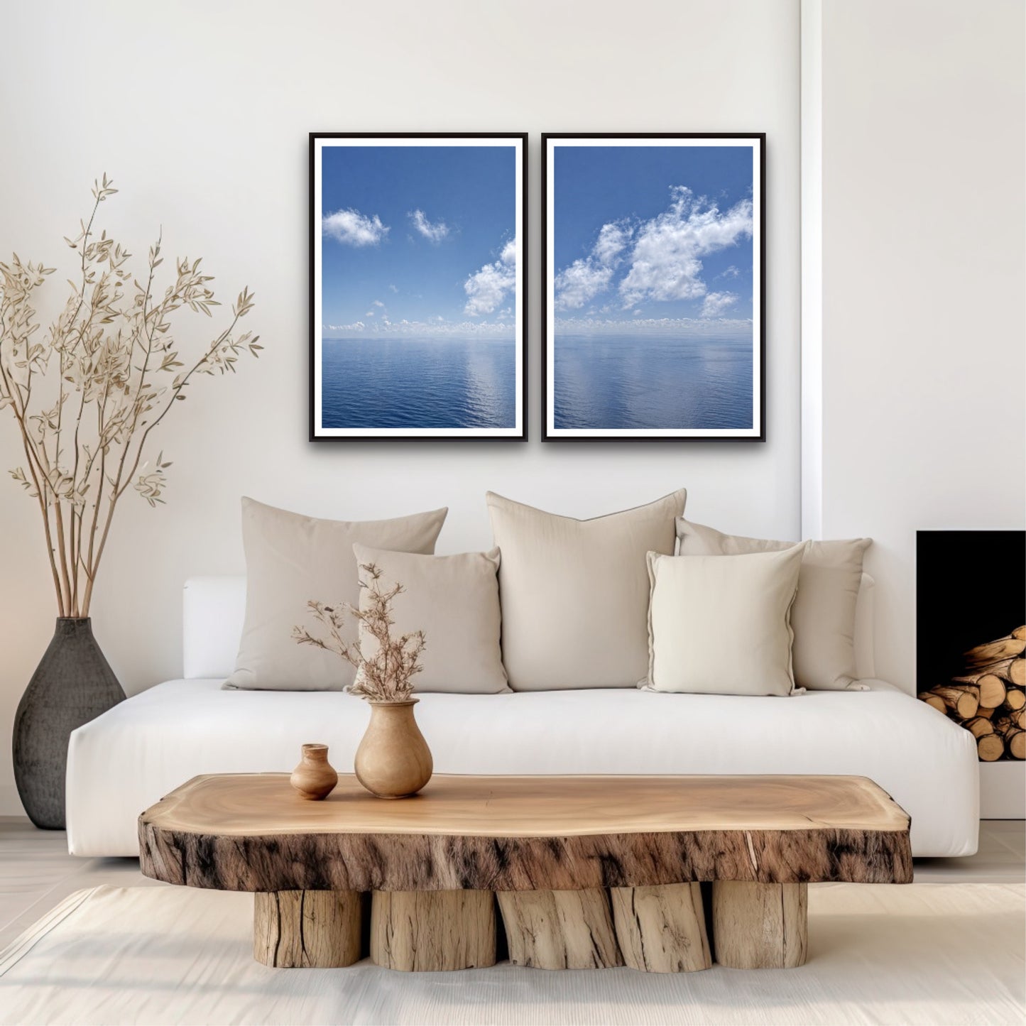 Modern living room with a white sofa, wooden coffee table, and two framed blue ocean prints.