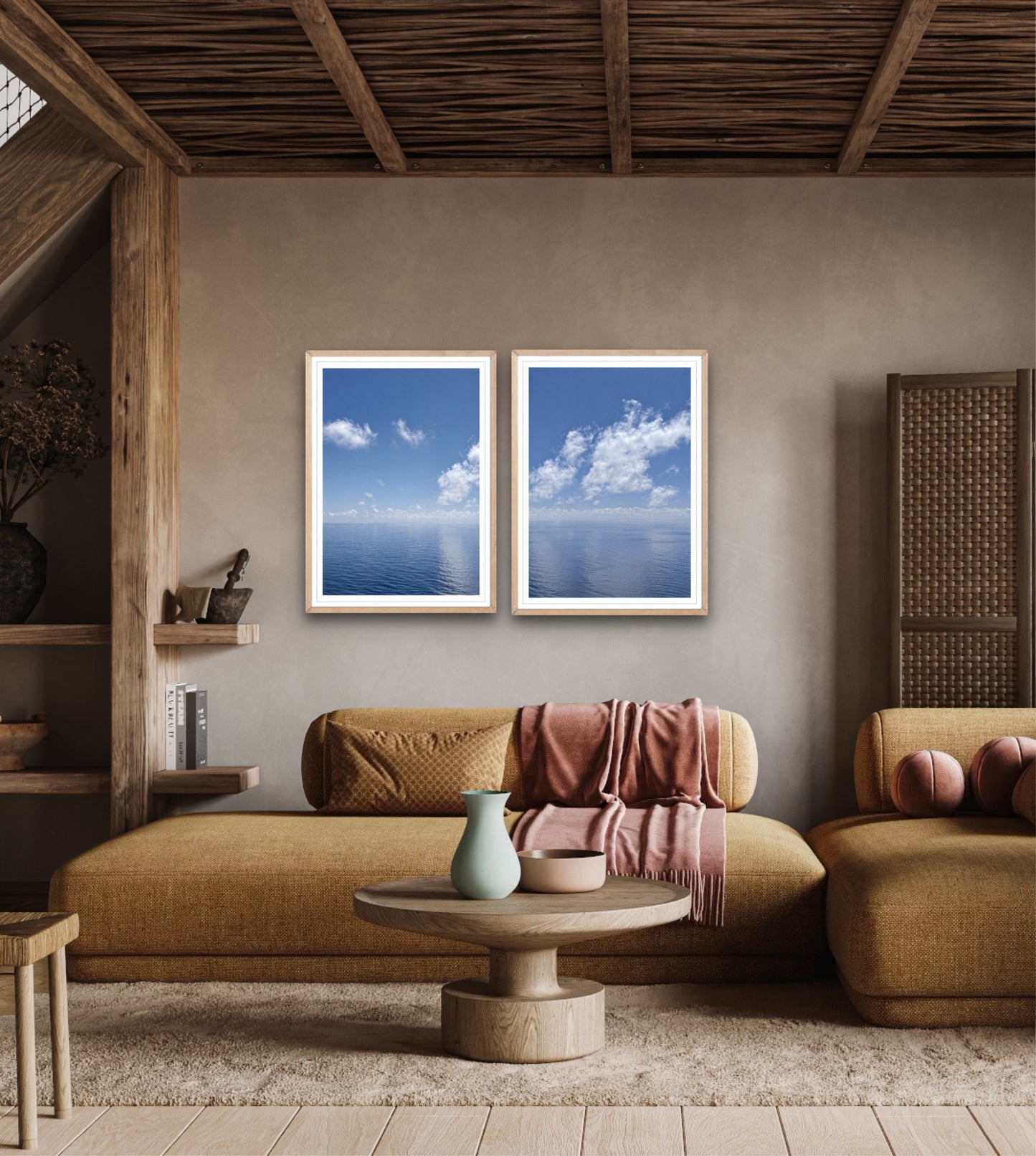 Living room with two framed blue sky and cloud pictures on a wall.