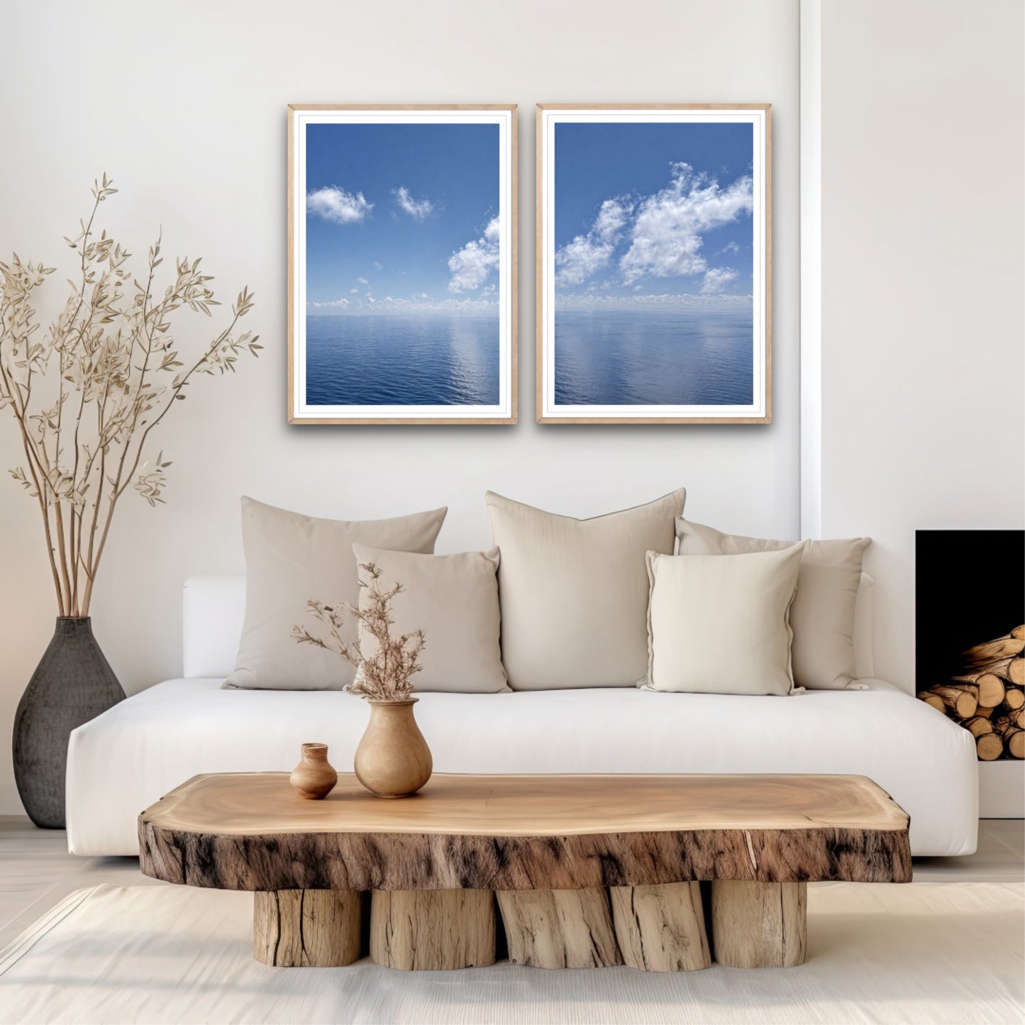 Living room with a white sofa, wooden coffee table, and two framed blue ocean artworks.