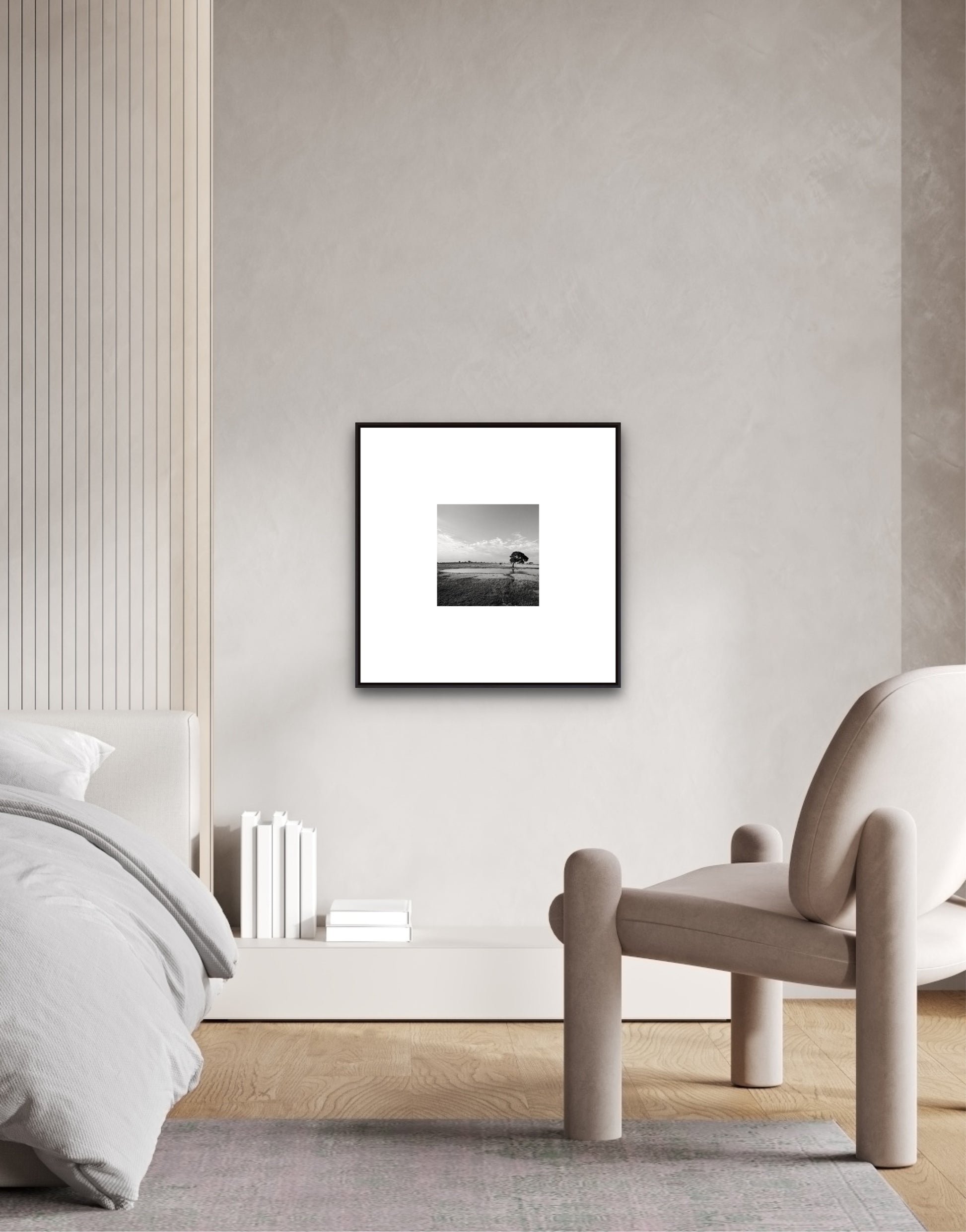 Framed black and white artwork on a wall in a modern bedroom.