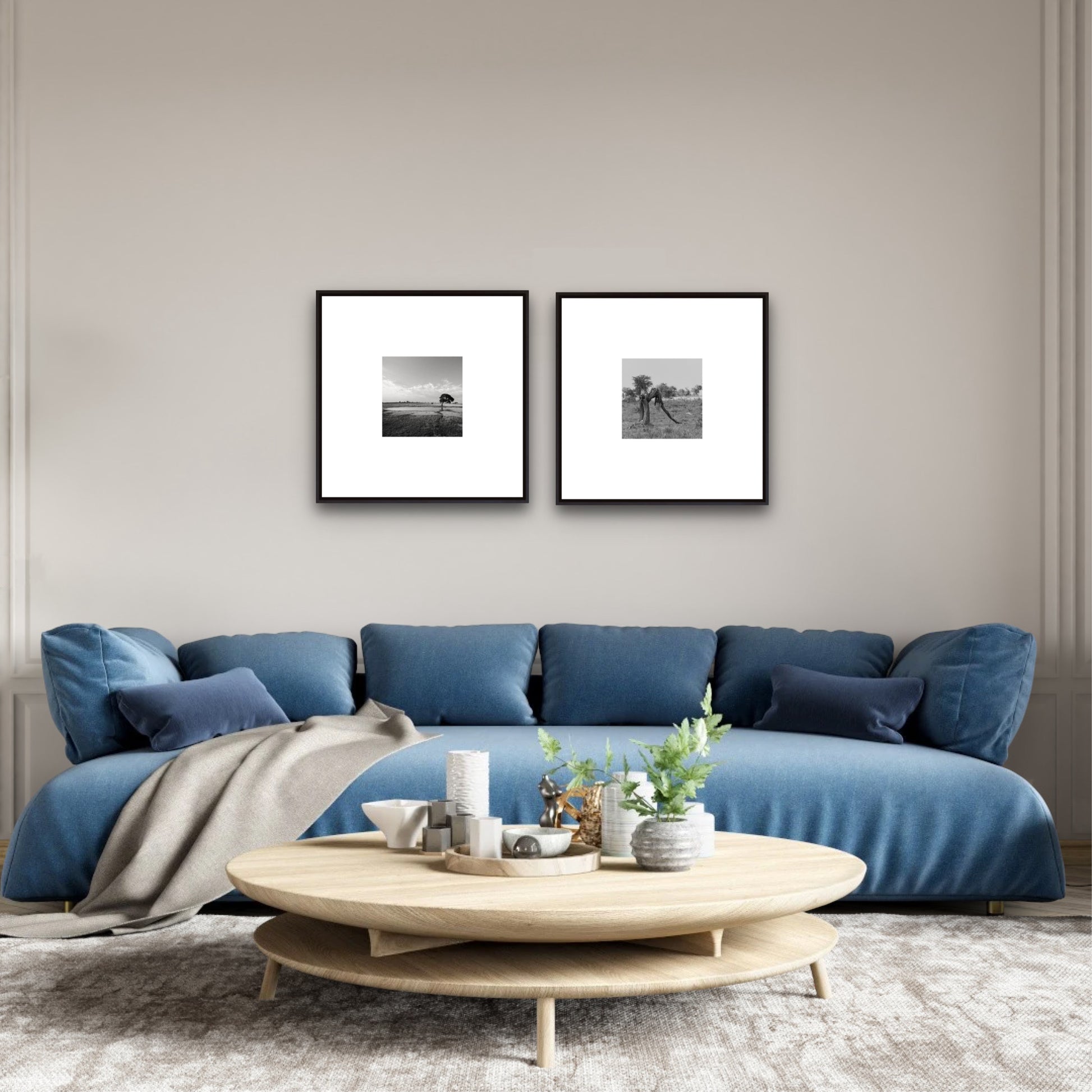 Modern living room with a blue sofa, wooden coffee table, and framed pictures on the wall.