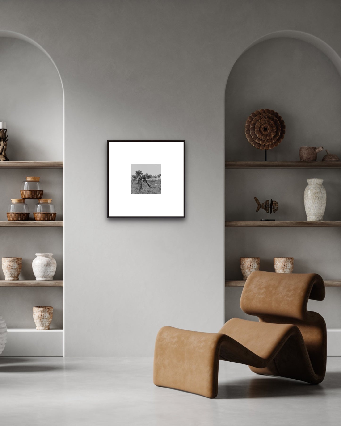 Modern interior with a brown chair, shelves with decorative items, and a framed picture on a gray wall.