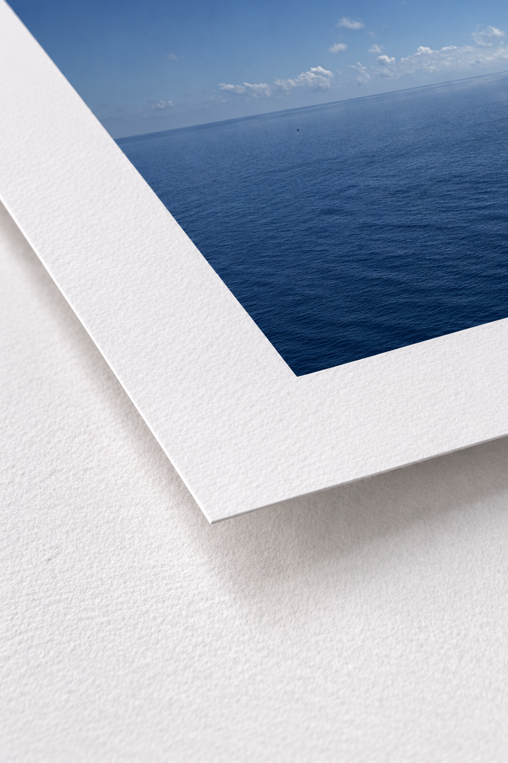 Close-up of a white frame with a view of the ocean and sky.
